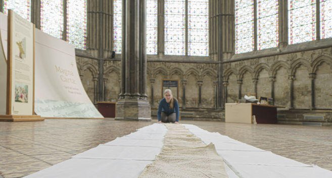 Salisbury Cathedral Archivist Emily Naish with a scroll