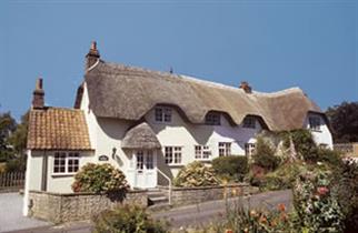 Semi-detached 250 year old thatched cottage in conservation area.