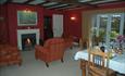 Breakfast room with guests lounge and log fire.