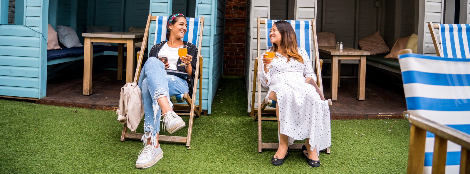 Two girls having a drink outside