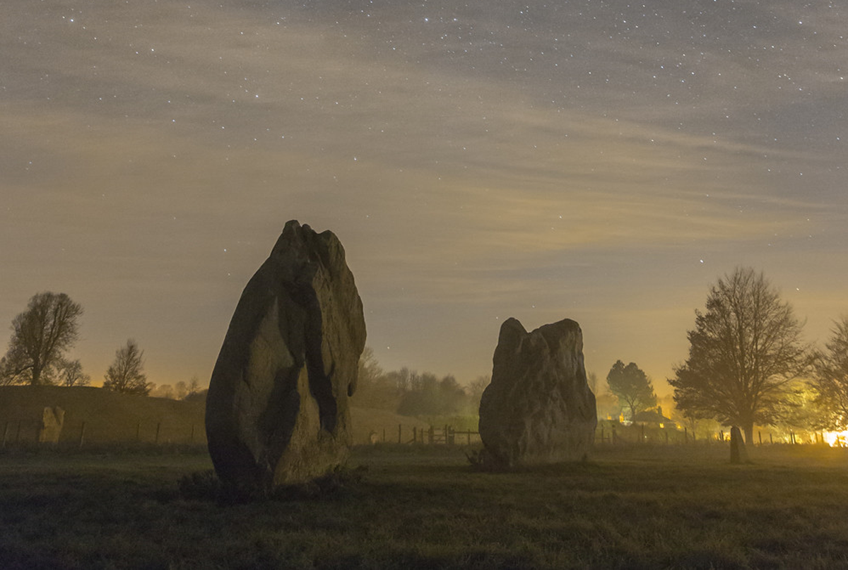 standing stones at dawn with stars above