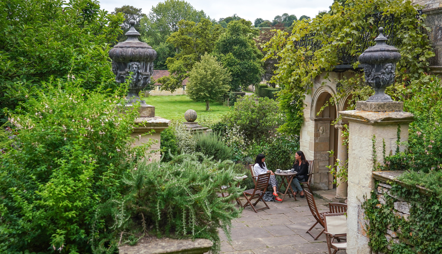 Women having coffee in the garden at Iford Manor