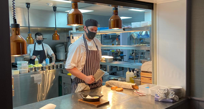 Chefs in the kitchen wearing masks