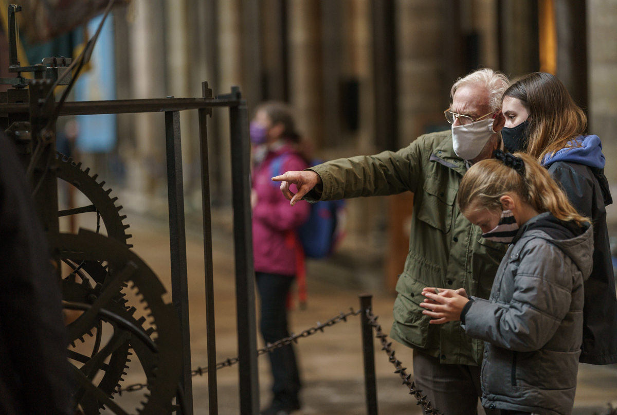 Family wearing masks looking at historic church inside the cathedral