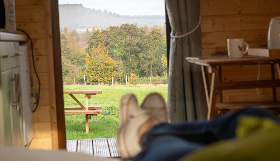 A small cabin with views to the hills in the distance