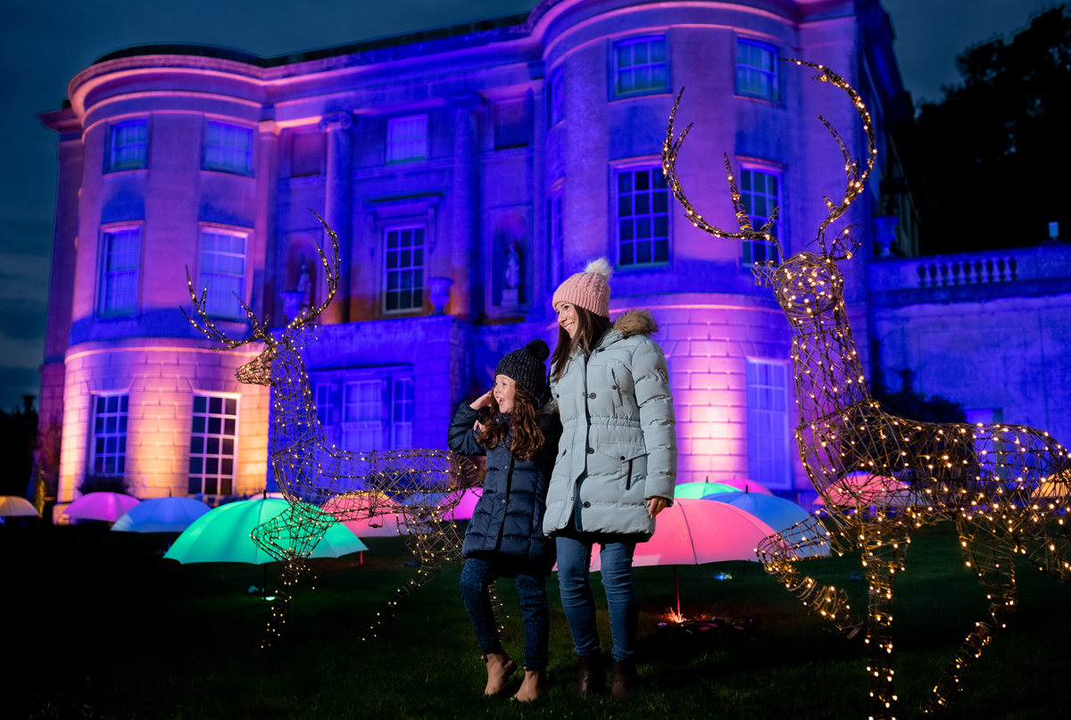 woman and girl outside surrounded by christmas lights