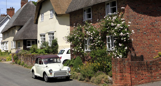 Classic car outside Wiltshire cottages