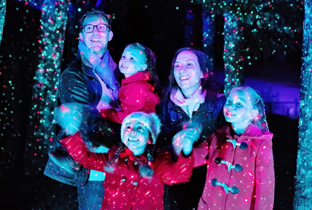 A family admiring the Christmas lights