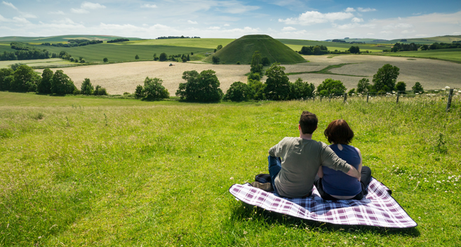 Couple having a picnic overlooking Silbury Hill