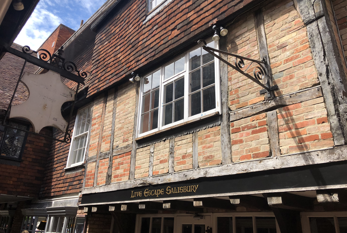 historic building with sign for salisbury escape rooms