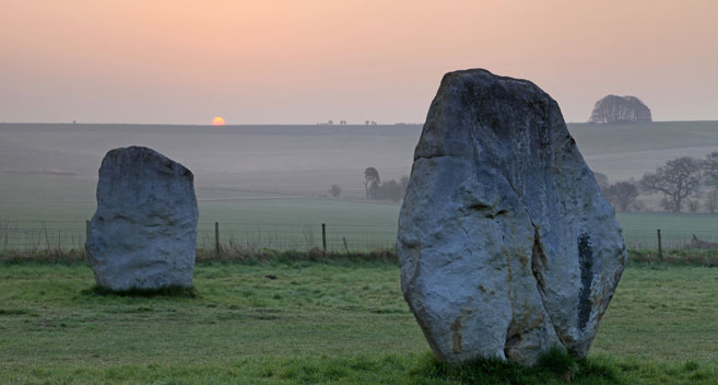 standing stones at Avebury Henge at sunrise