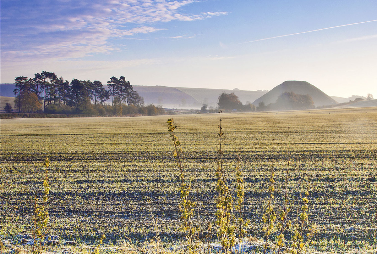 frost covered ground with silbury hill in the background